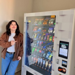 a person standing next to a vending machine