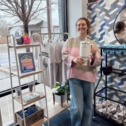 a person in a store holding a large thermos