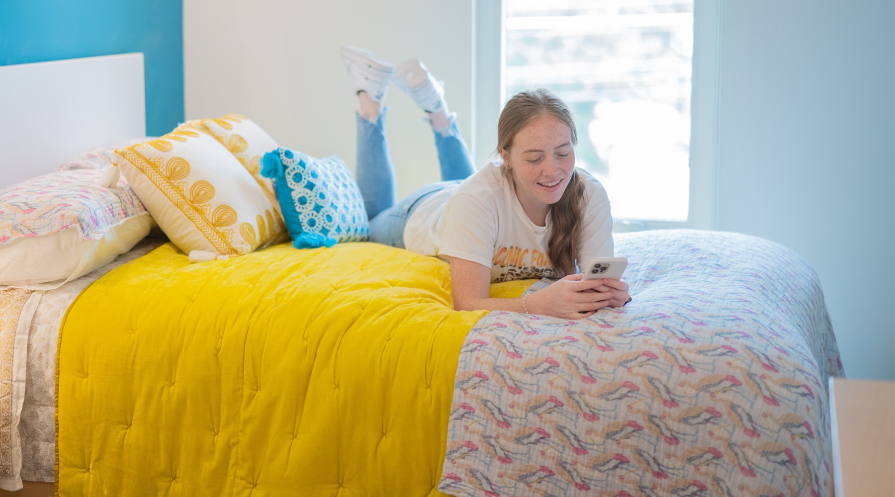 Girl laying on her bed studying