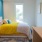 Spacious and well lit bedroom with plush carpet and large windows