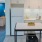 Spacious and well lit kitchen with tile floors and white appliances 